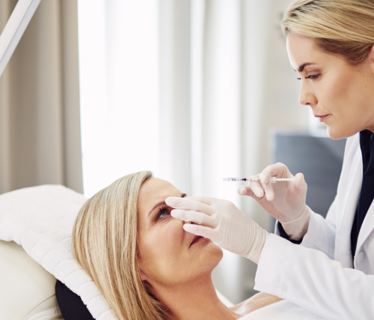 A woman is getting her eye examined by an ophthalmologist.