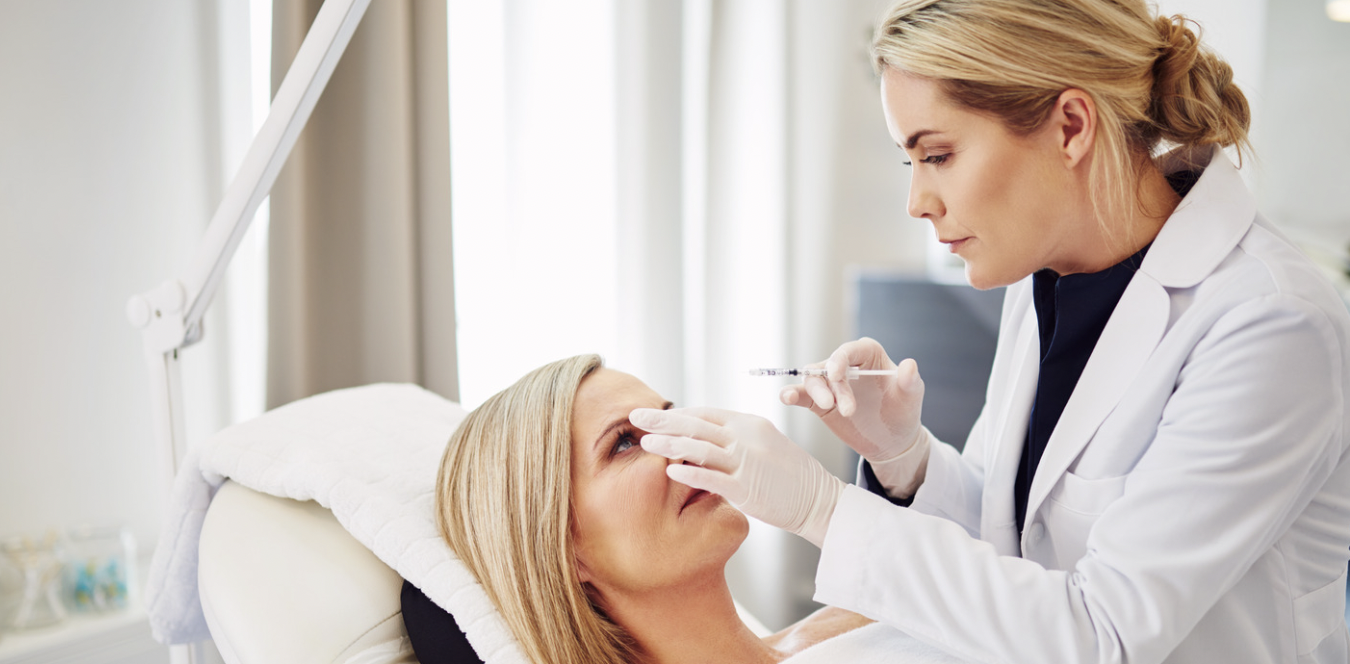 A woman is getting her eye examined by an ophthalmologist.