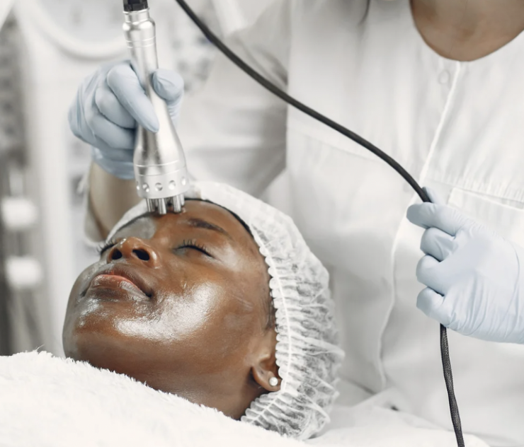 A woman getting her face waxed at the spa