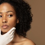 A woman with curly hair and gloves on her hands.