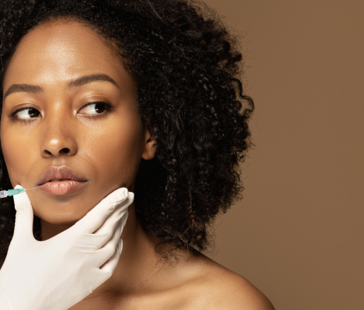 A woman with curly hair and gloves on her hands.