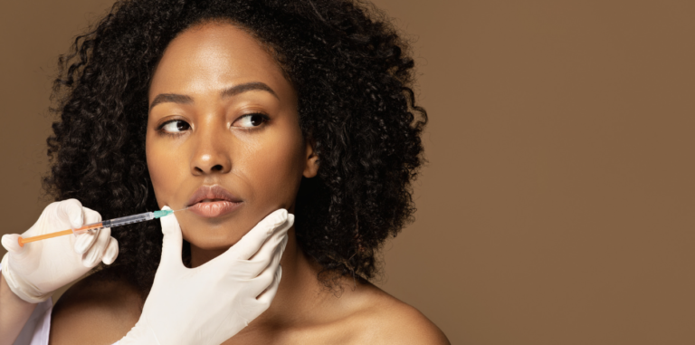 A woman with curly hair and gloves on her hands.